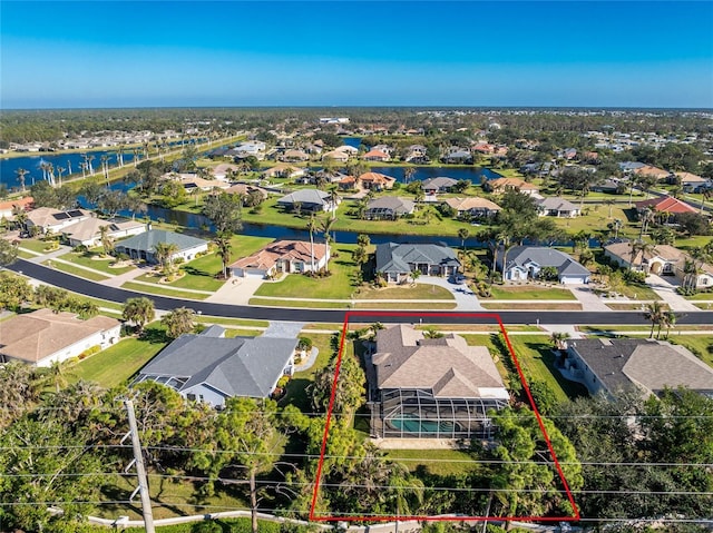 birds eye view of property with a water view