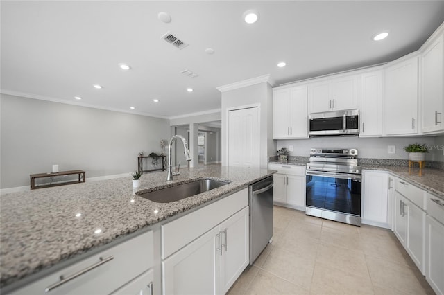 kitchen featuring light stone countertops, appliances with stainless steel finishes, crown molding, sink, and white cabinetry