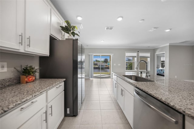 kitchen featuring white cabinetry, sink, light stone counters, appliances with stainless steel finishes, and ornamental molding