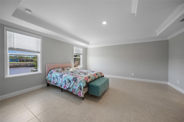 tiled bedroom with ornamental molding and a tray ceiling