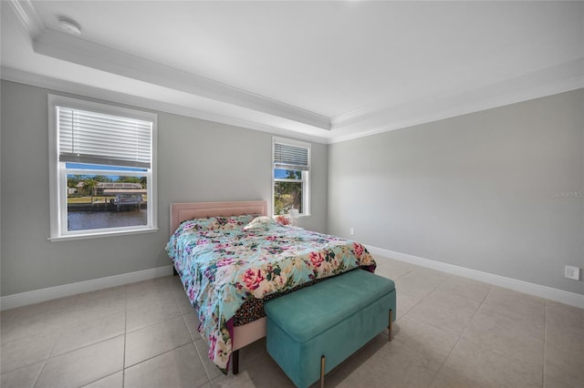 tiled bedroom with a raised ceiling and ornamental molding