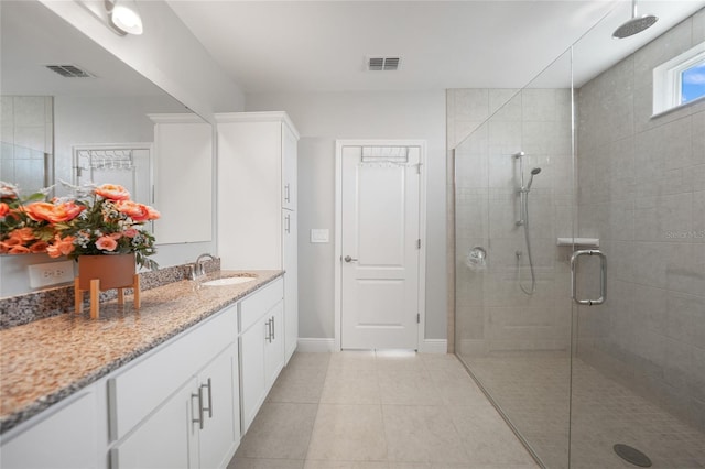 bathroom featuring tile patterned floors, vanity, and an enclosed shower