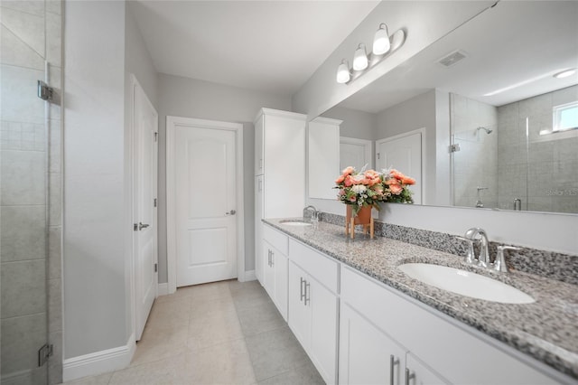 bathroom featuring vanity, tile patterned floors, and an enclosed shower