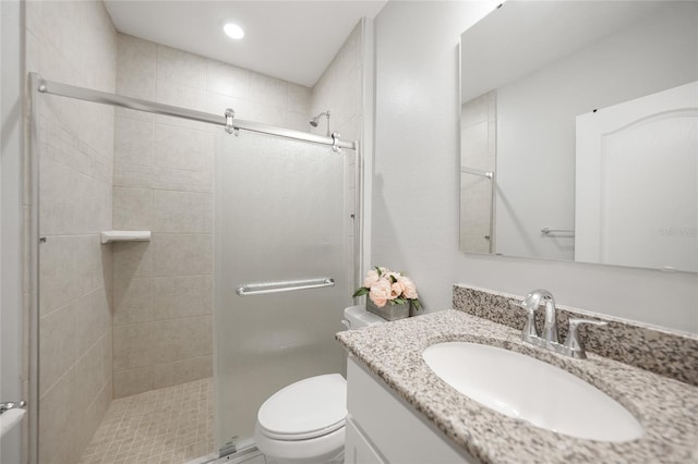 bathroom with vanity, toilet, and walk in shower