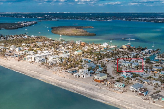 birds eye view of property with a beach view and a water view