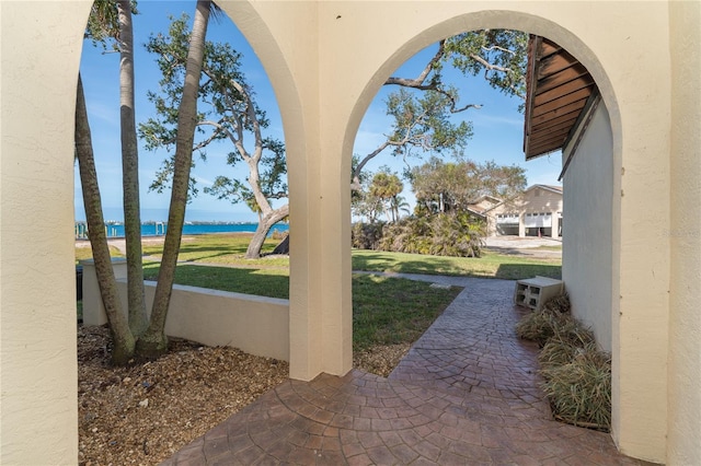 view of yard featuring a water view and a patio area