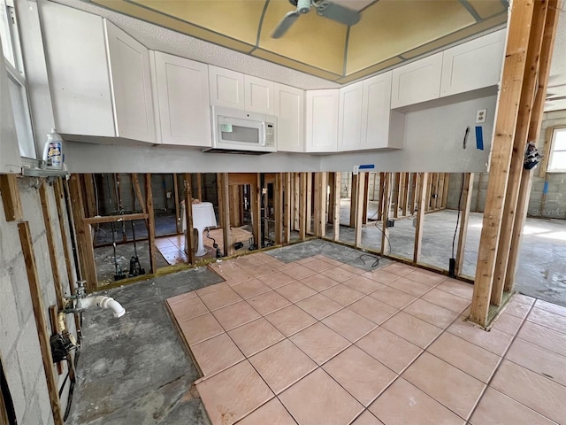 kitchen with white cabinetry and ceiling fan