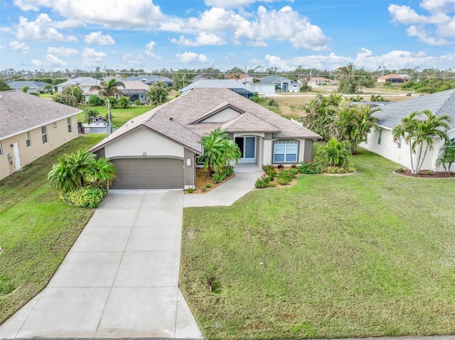 view of front of property with a garage and a front lawn