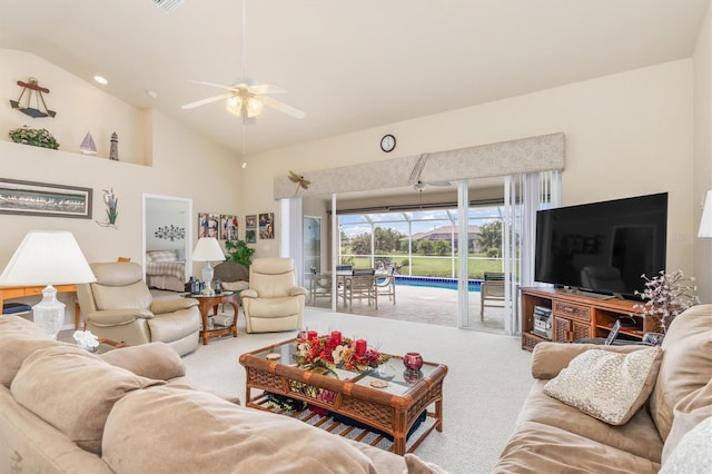 carpeted living area featuring a ceiling fan and high vaulted ceiling