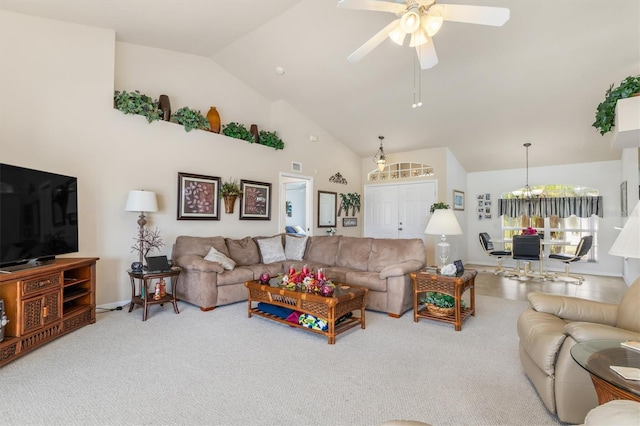 carpeted living room with baseboards, visible vents, high vaulted ceiling, and ceiling fan