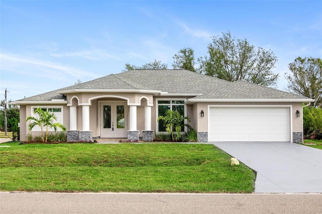 view of front of home with a garage, a front yard, and french doors