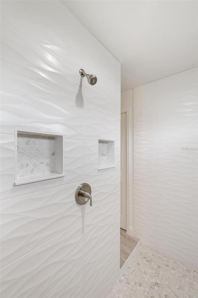 bathroom with tiled shower