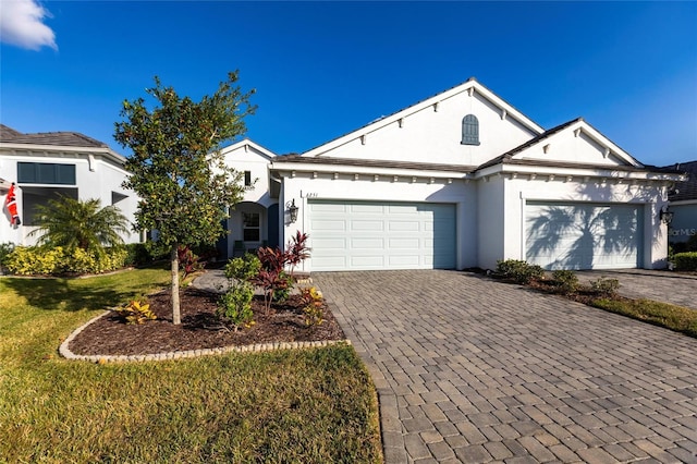 single story home with a front yard and a garage