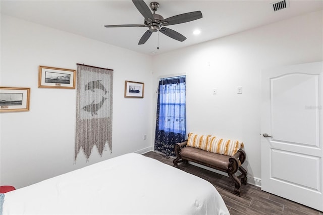 bedroom with ceiling fan and dark hardwood / wood-style floors