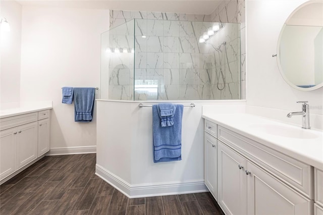 bathroom with vanity and tiled shower