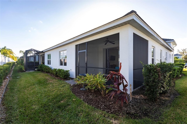 rear view of property featuring a lanai and a lawn