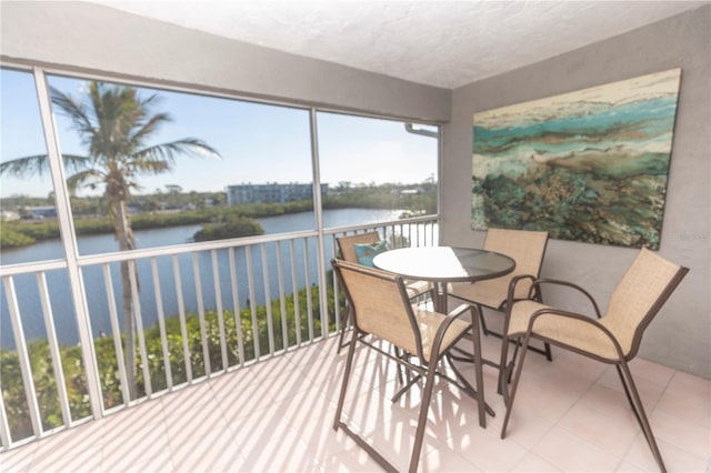 sunroom / solarium featuring a water view and a healthy amount of sunlight