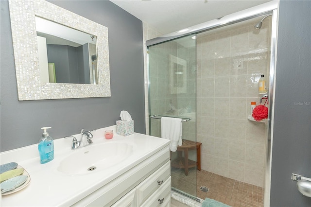 bathroom with vanity and a shower with door