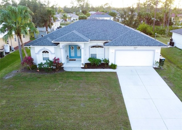 view of front of home with a front lawn and a garage