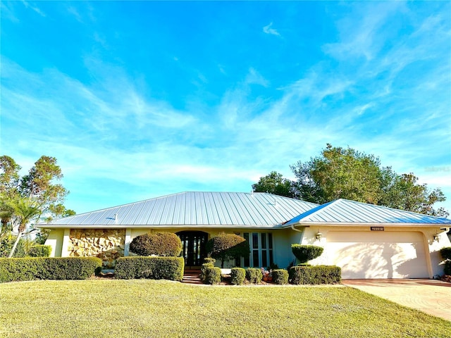 ranch-style home with a front yard and a garage