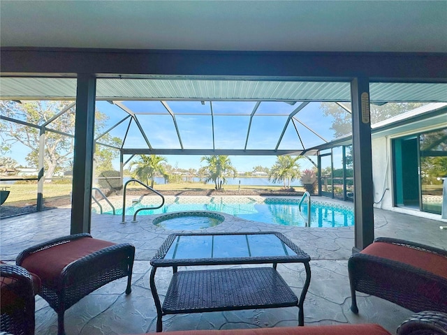 view of swimming pool with glass enclosure, an in ground hot tub, and a patio