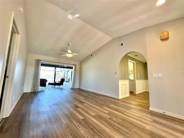 spare room with ceiling fan, wood-type flooring, and vaulted ceiling