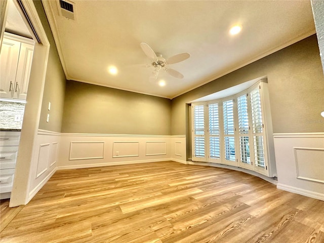 unfurnished room featuring light hardwood / wood-style floors, ceiling fan, and ornamental molding