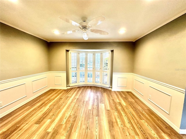 unfurnished room with light wood-type flooring, ceiling fan, and crown molding