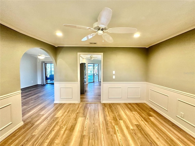 unfurnished room featuring light wood-type flooring and ornamental molding