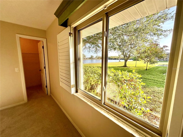 hall featuring carpet flooring and a water view