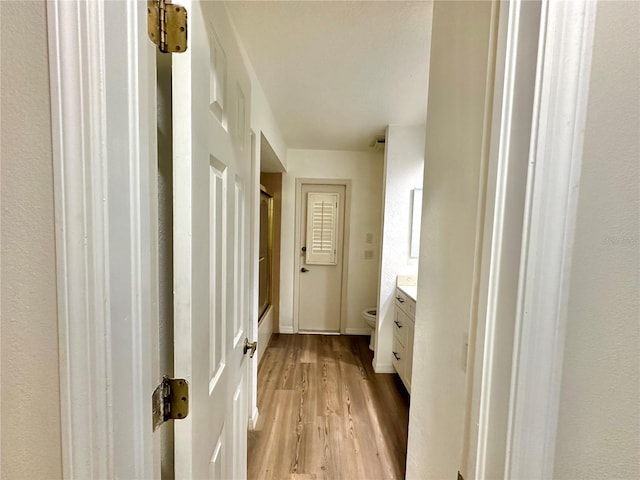 bathroom featuring vanity, hardwood / wood-style flooring, toilet, and a shower with door