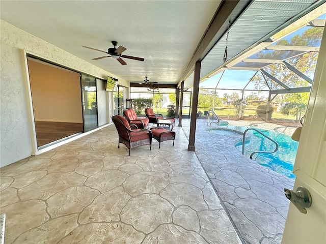 exterior space featuring glass enclosure and ceiling fan