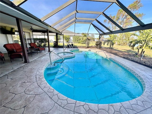 view of swimming pool featuring an in ground hot tub, a patio, glass enclosure, and ceiling fan