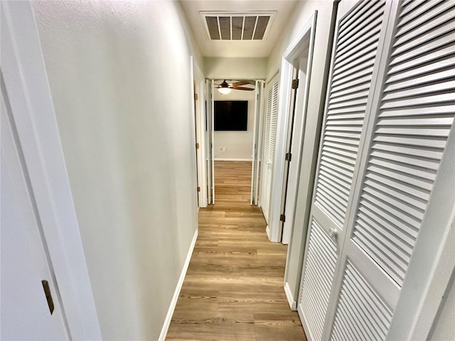 corridor featuring light hardwood / wood-style floors