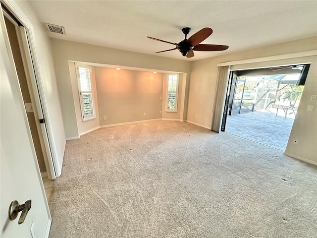 carpeted spare room with ceiling fan