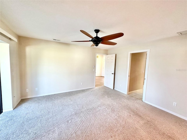 unfurnished room featuring light carpet and ceiling fan