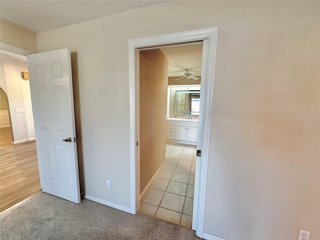 corridor with sink and light hardwood / wood-style flooring