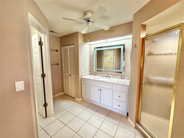 bathroom featuring vanity, tile patterned floors, walk in shower, and ceiling fan