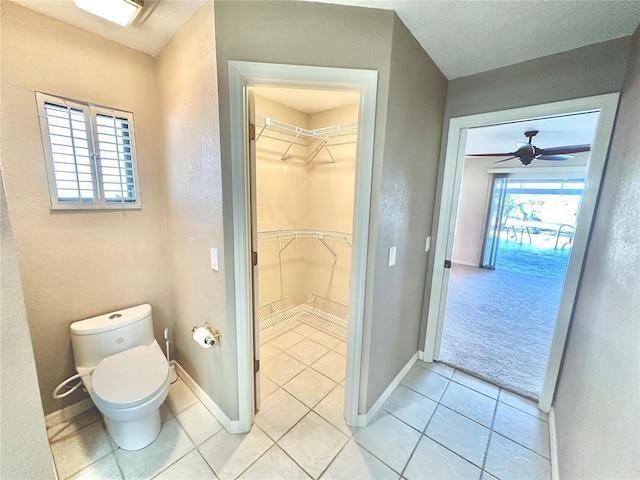 bathroom with tile patterned flooring, ceiling fan, and toilet