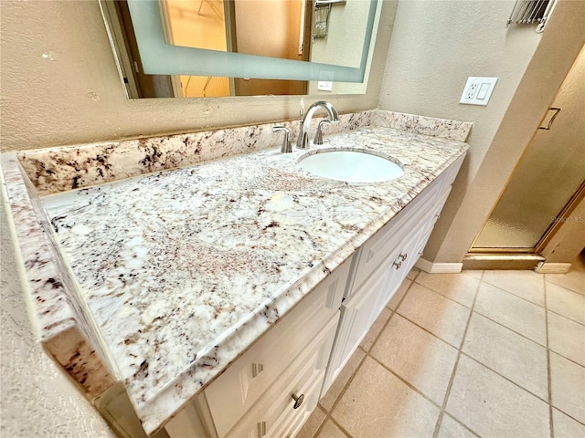 bathroom with tile patterned flooring and vanity