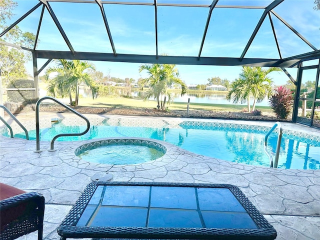 view of pool featuring glass enclosure, a water view, and an in ground hot tub