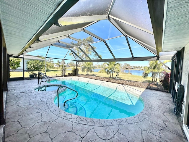 view of pool with a water view, glass enclosure, and a patio area