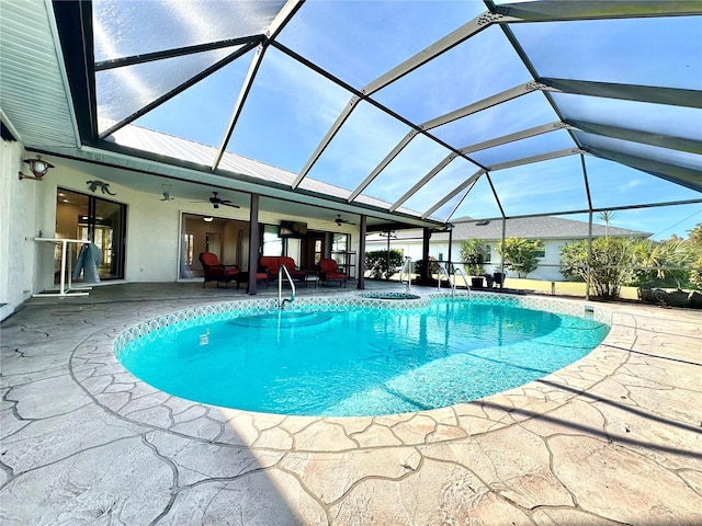 view of swimming pool featuring ceiling fan, a lanai, an outdoor living space, and a patio