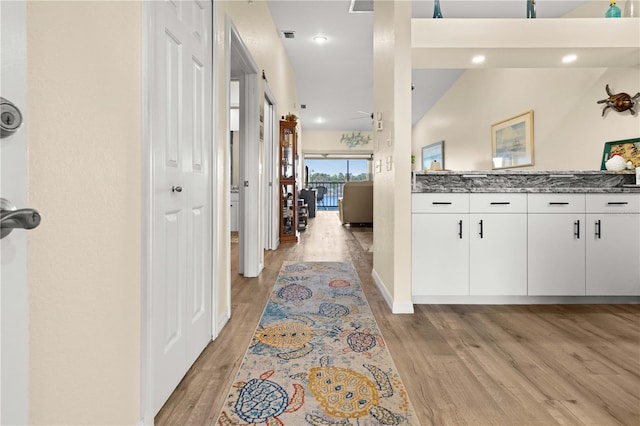 corridor with light hardwood / wood-style floors