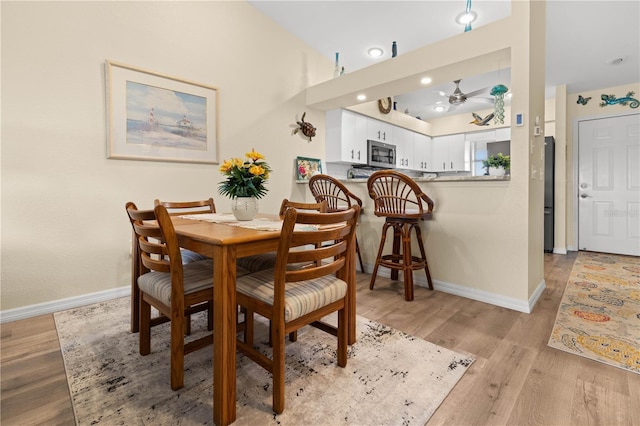 dining space featuring light hardwood / wood-style floors and ceiling fan