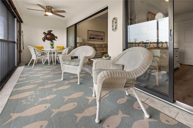 sunroom / solarium featuring ceiling fan