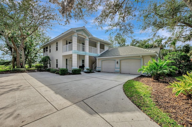 view of front of property with a garage and a balcony