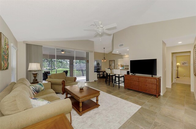 living room with ceiling fan and lofted ceiling