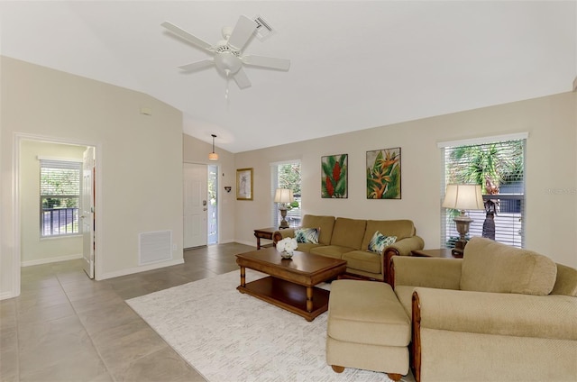 tiled living room featuring ceiling fan and vaulted ceiling