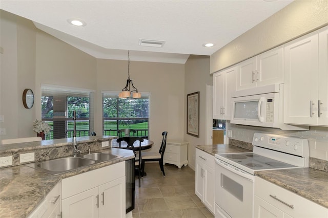 kitchen featuring sink, light tile patterned floors, decorative light fixtures, white appliances, and white cabinets